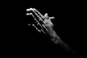 Hands clasped in prayer